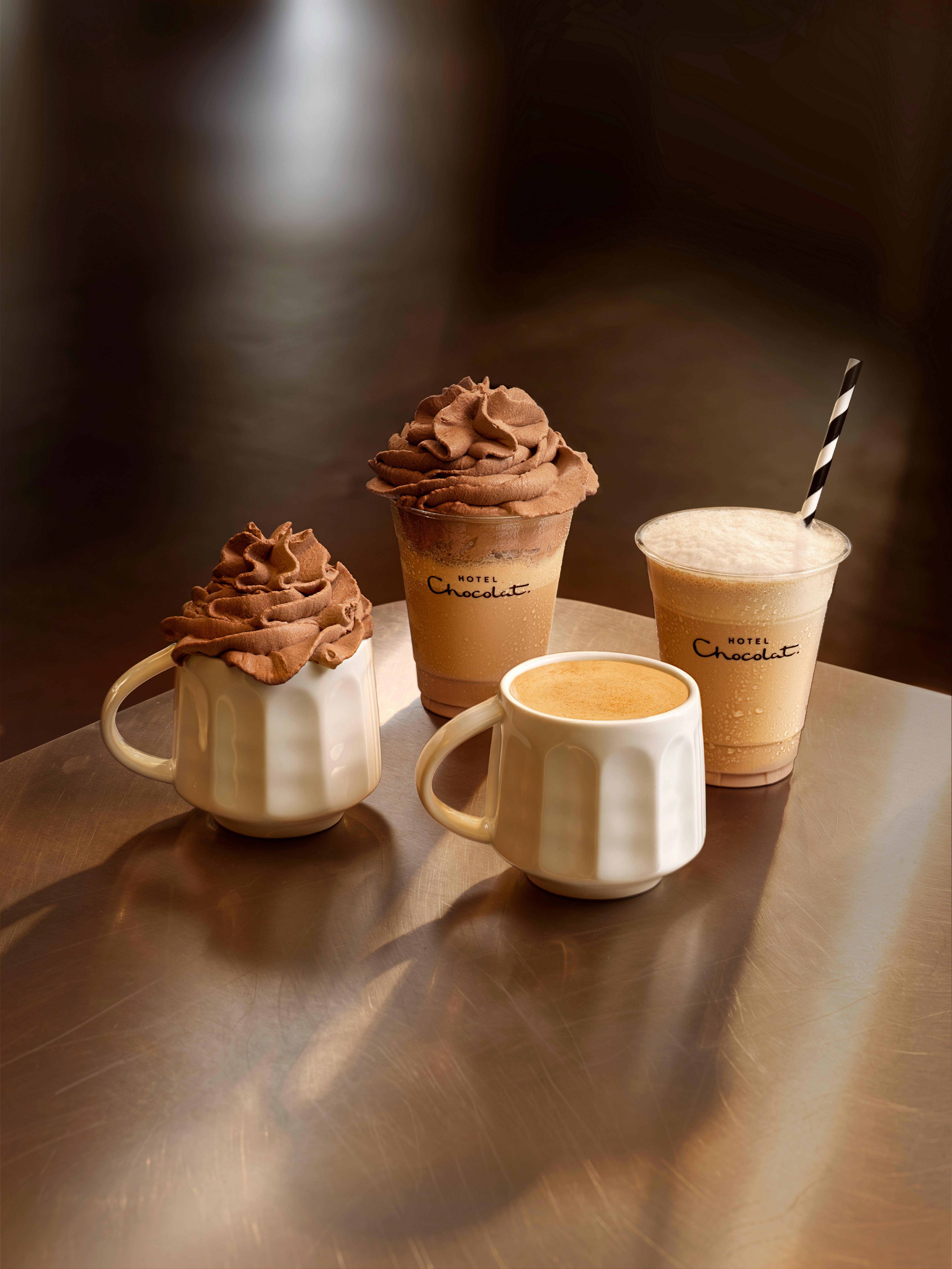 a tray of three cups of coffee on a table