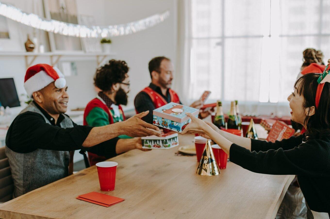 Colleagues-exchanging-Christmas-gifts-in-office