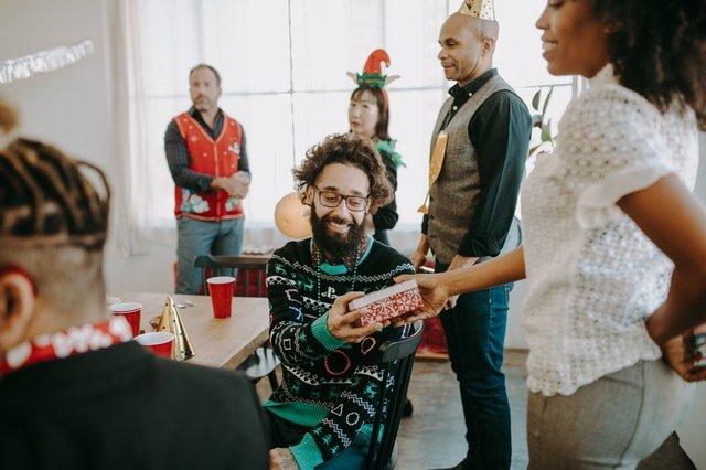 Colleagues-exchanging-gifts-at-an-office-Christmas-party