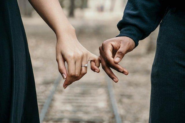 Engaged-couple-holding-hands