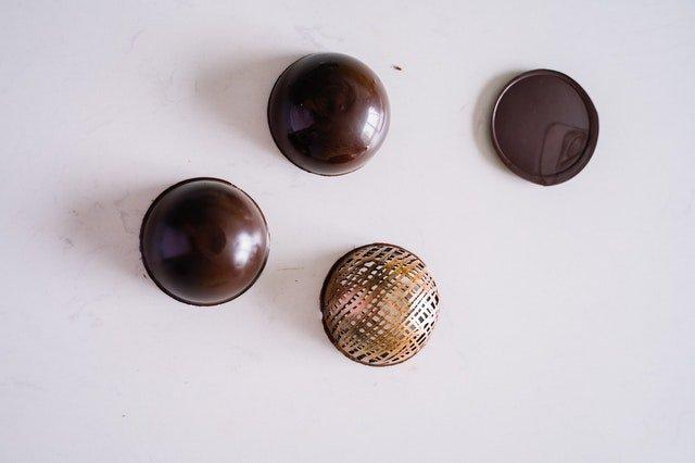 Four-half-chocolate-spheres-on-a-white-counter