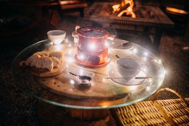 Table-with-fairy-lights-and-a-red-fondue-set