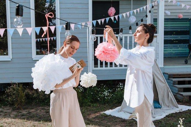 Two-women-putting-party-decorations-up