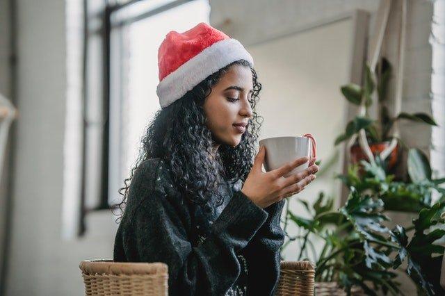 Woman-in-a-Santa-hat-drinking-from-a-mug