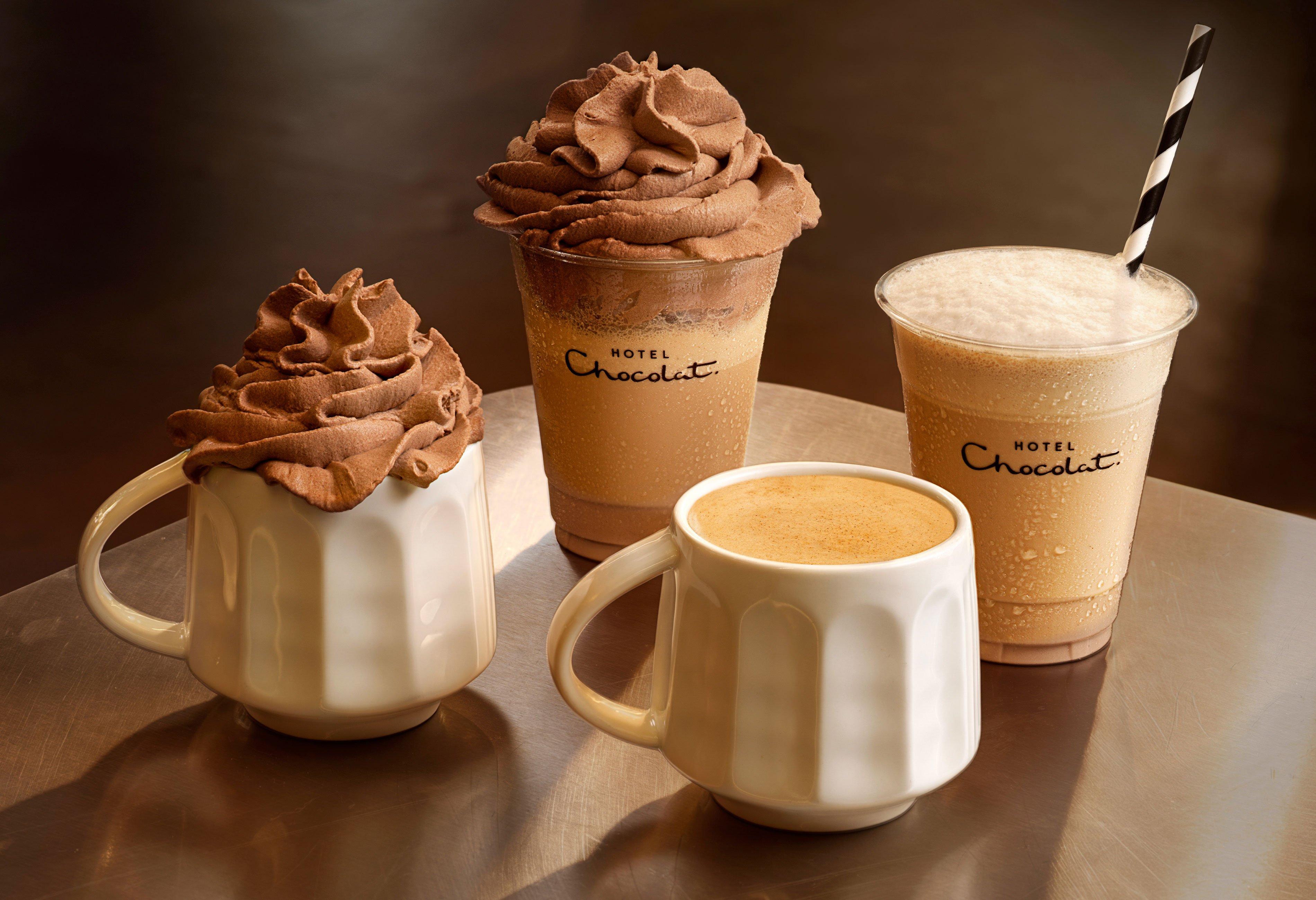 a tray of three cups of coffee on a table