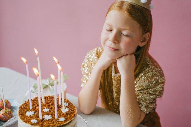 child-with-birthday-cake-and-candles