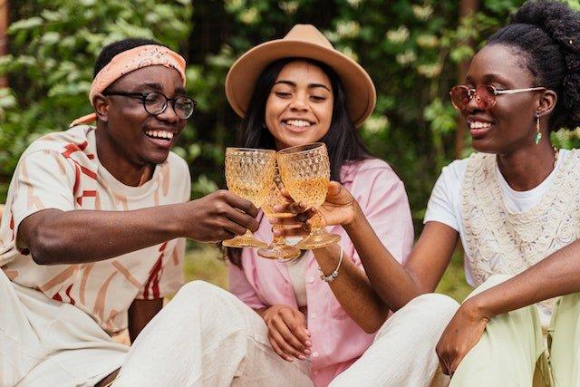 friends-toasting-drinks-in-orange-glasses