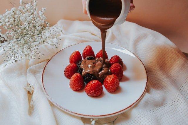 melted-chocolate-pouring-over-strawberries